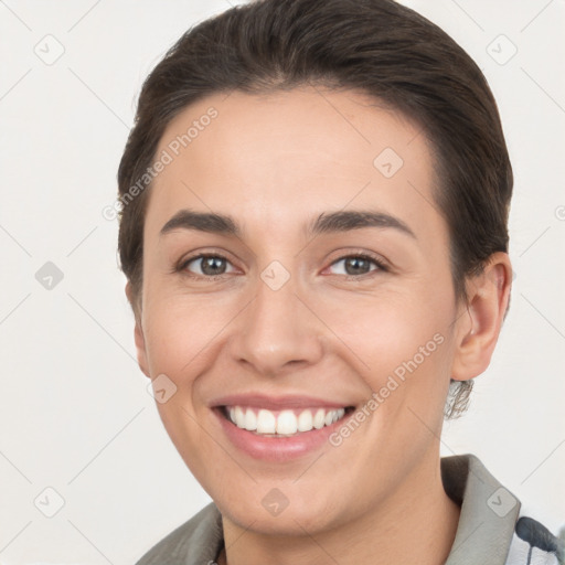 Joyful white young-adult female with short  brown hair and brown eyes