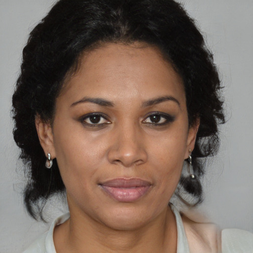 Joyful black adult female with medium  brown hair and brown eyes