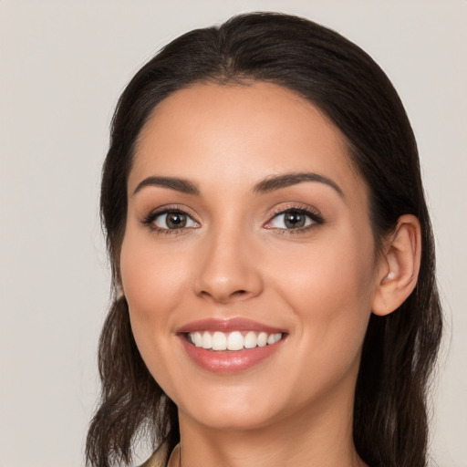 Joyful white young-adult female with long  brown hair and brown eyes