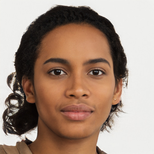 Joyful black young-adult female with long  brown hair and brown eyes