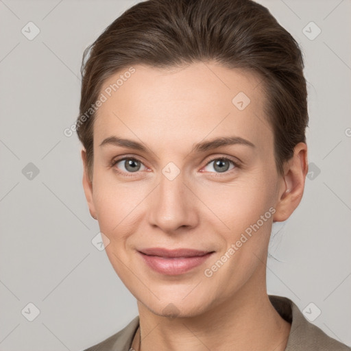 Joyful white young-adult female with short  brown hair and grey eyes