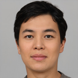 Joyful asian young-adult male with short  black hair and brown eyes