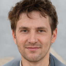 Joyful white adult male with short  brown hair and brown eyes