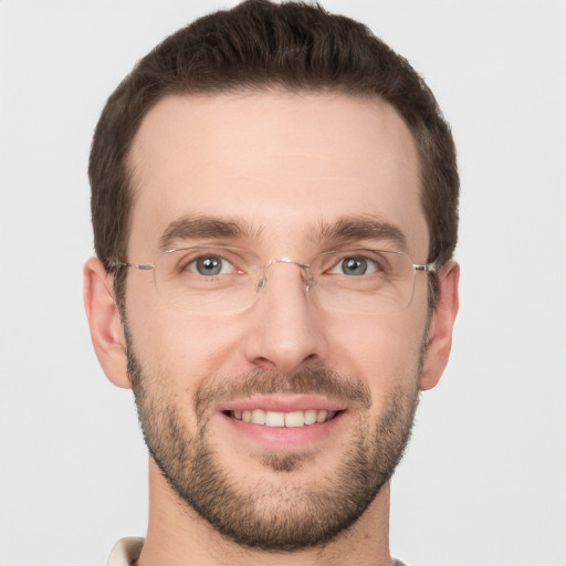 Joyful white young-adult male with short  brown hair and grey eyes