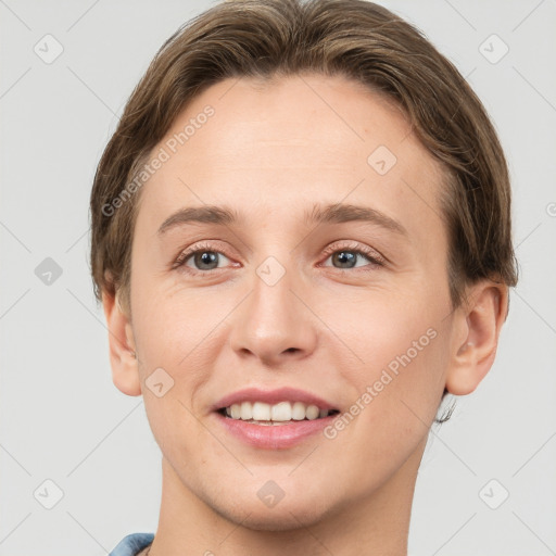 Joyful white young-adult female with short  brown hair and grey eyes