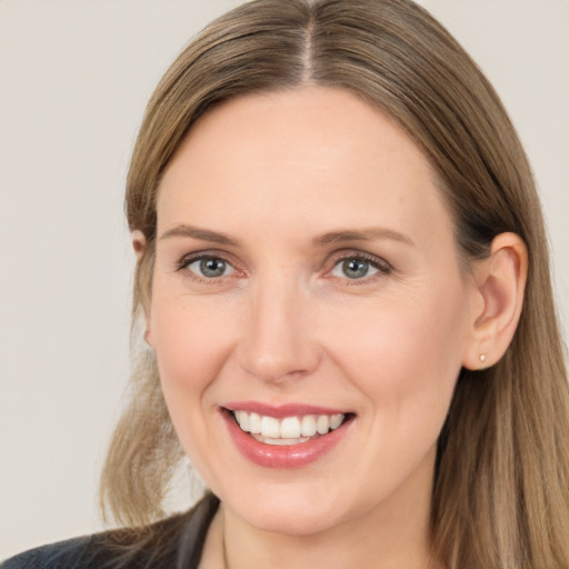 Joyful white adult female with long  brown hair and brown eyes