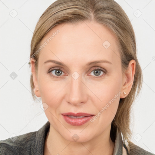 Joyful white adult female with medium  brown hair and blue eyes