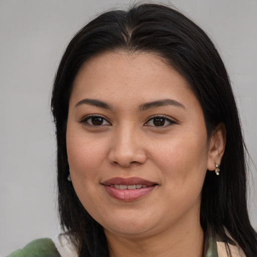 Joyful asian young-adult female with long  brown hair and brown eyes