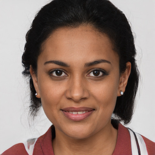 Joyful latino young-adult female with medium  brown hair and brown eyes