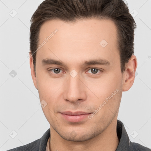 Joyful white young-adult male with short  brown hair and brown eyes