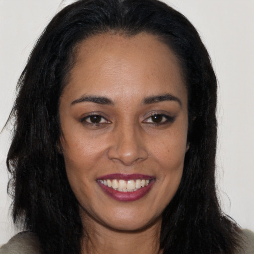 Joyful latino young-adult female with long  brown hair and brown eyes