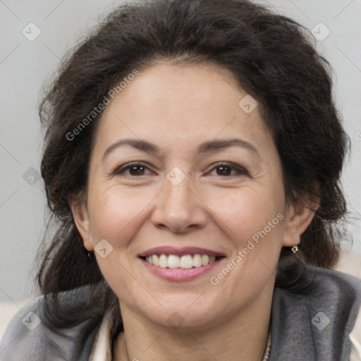 Joyful white adult female with long  brown hair and brown eyes