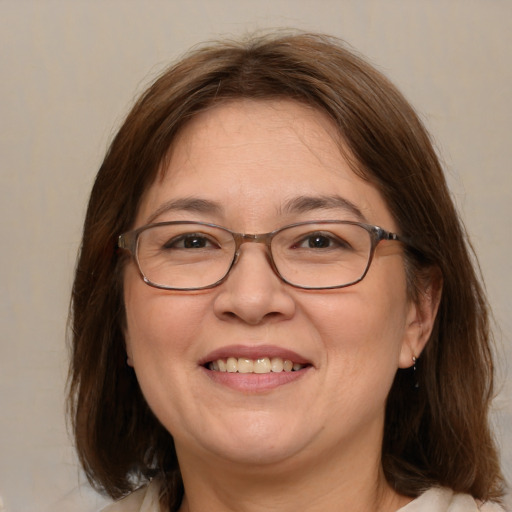 Joyful white adult female with medium  brown hair and brown eyes