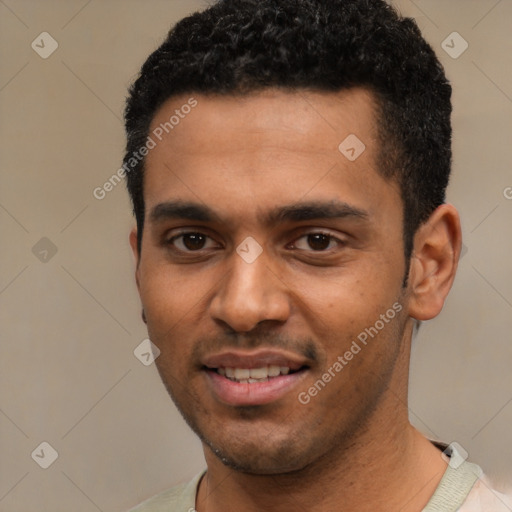 Joyful black young-adult male with short  black hair and brown eyes