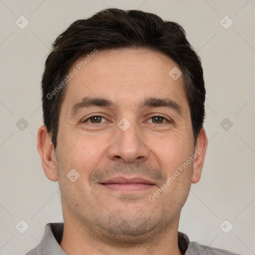 Joyful white adult male with short  brown hair and brown eyes