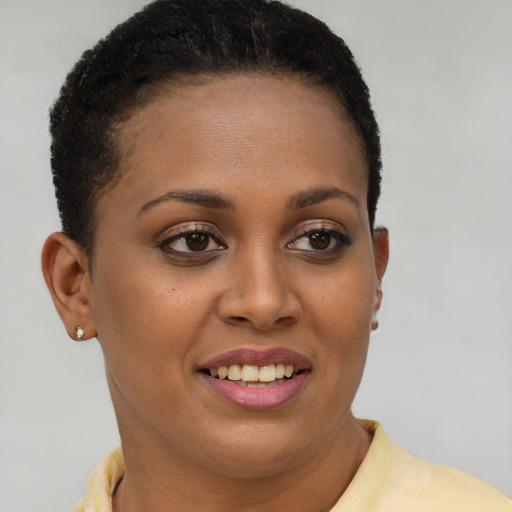 Joyful black young-adult female with short  brown hair and brown eyes
