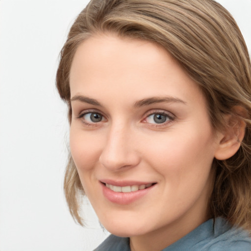 Joyful white young-adult female with medium  brown hair and blue eyes