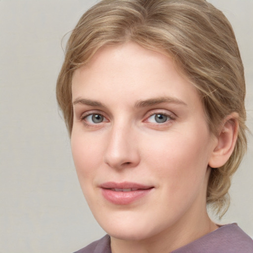 Joyful white young-adult female with medium  brown hair and blue eyes