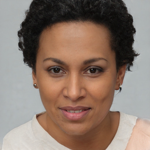Joyful latino young-adult female with short  brown hair and brown eyes