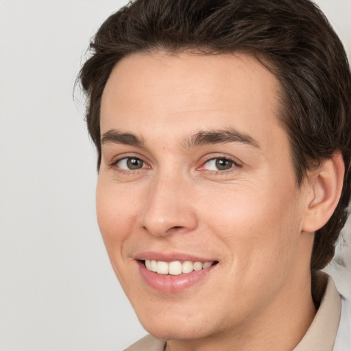 Joyful white young-adult male with medium  brown hair and brown eyes