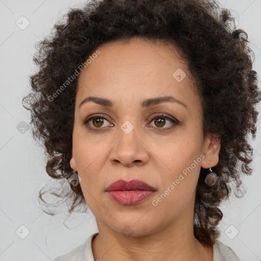 Joyful black adult female with medium  brown hair and brown eyes