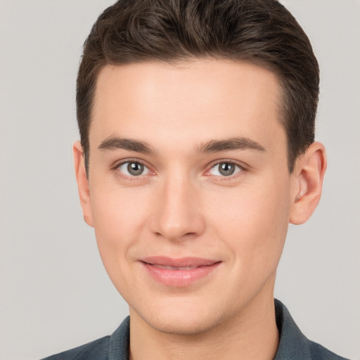 Joyful white young-adult male with short  brown hair and brown eyes