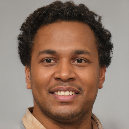 Joyful latino young-adult male with short  brown hair and brown eyes