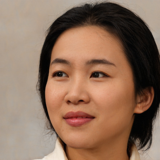 Joyful asian young-adult female with medium  brown hair and brown eyes
