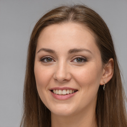 Joyful white young-adult female with long  brown hair and grey eyes