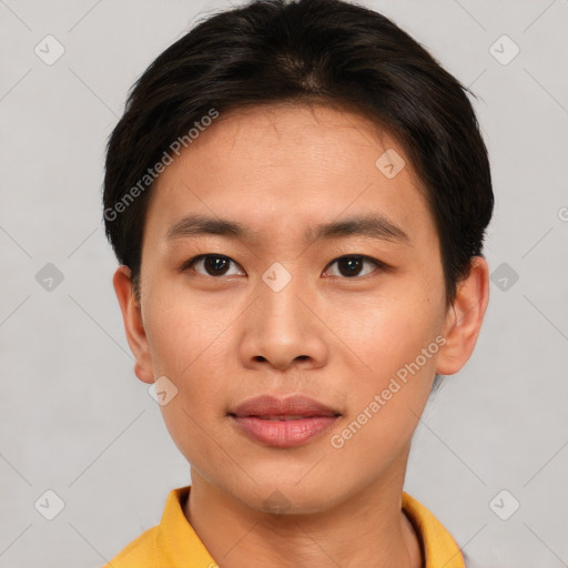 Joyful asian young-adult male with short  brown hair and brown eyes