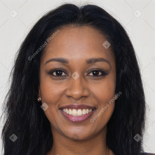 Joyful black young-adult female with long  brown hair and brown eyes