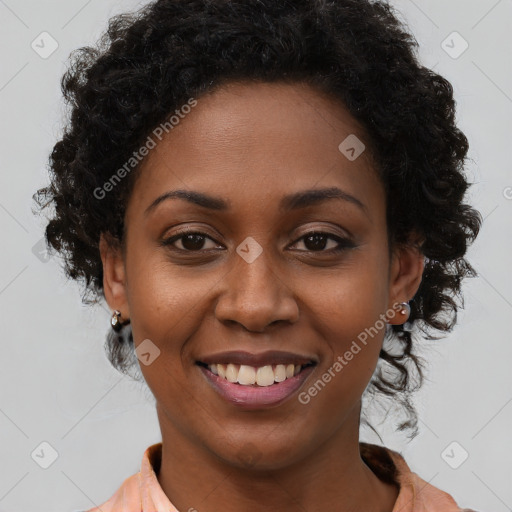 Joyful black young-adult female with long  brown hair and brown eyes