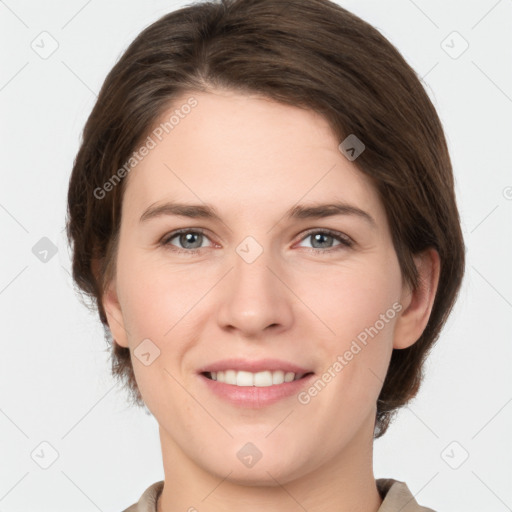 Joyful white young-adult female with medium  brown hair and grey eyes