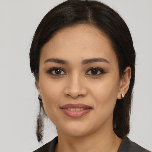 Joyful latino young-adult female with medium  brown hair and brown eyes