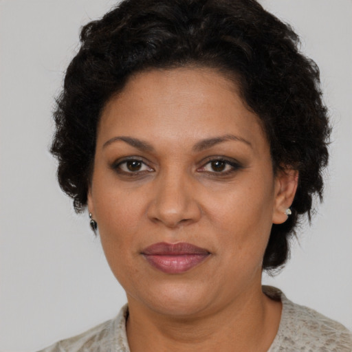 Joyful latino adult female with short  brown hair and brown eyes