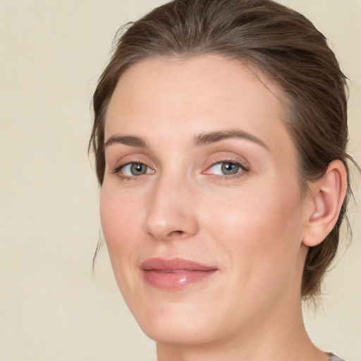 Joyful white young-adult female with medium  brown hair and green eyes