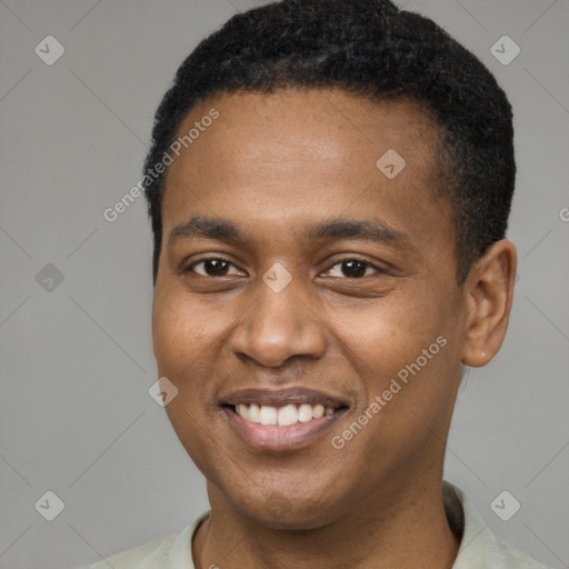 Joyful black young-adult male with short  brown hair and brown eyes