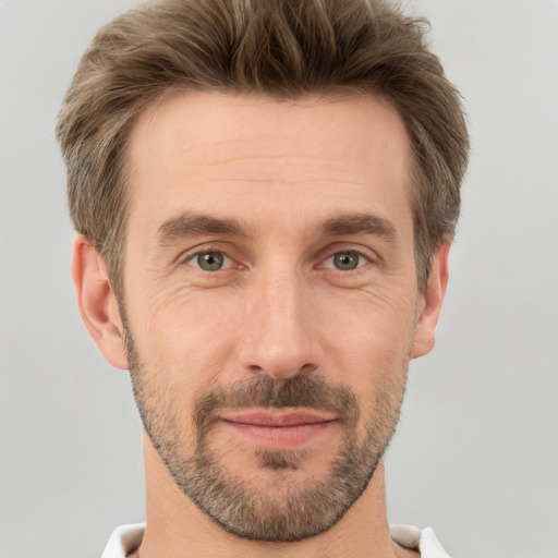 Joyful white adult male with short  brown hair and grey eyes