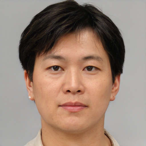 Neutral asian adult male with short  brown hair and brown eyes