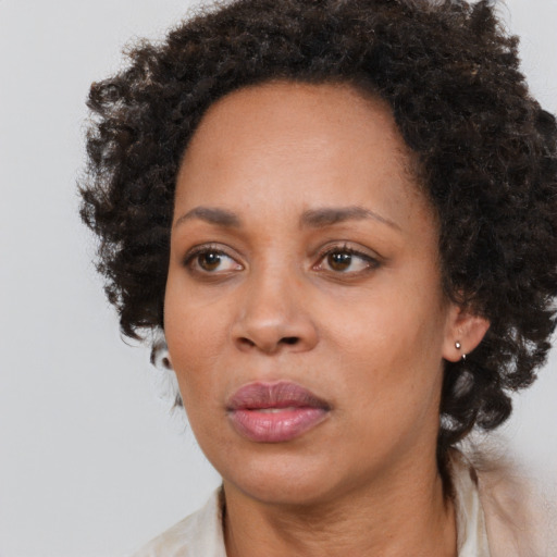 Neutral black adult female with medium  brown hair and brown eyes