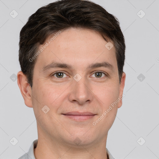 Joyful white adult male with short  brown hair and brown eyes