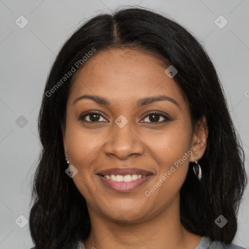 Joyful black young-adult female with long  brown hair and brown eyes