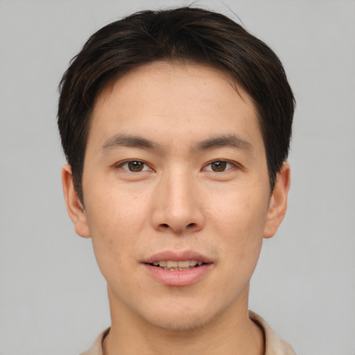 Joyful asian young-adult male with short  brown hair and brown eyes