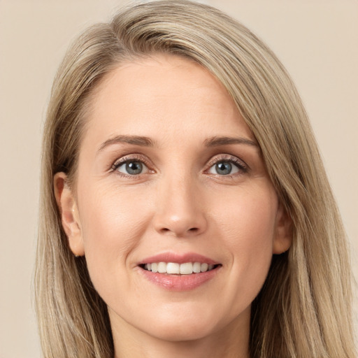 Joyful white young-adult female with long  brown hair and green eyes