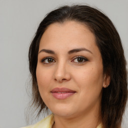 Joyful white young-adult female with medium  brown hair and brown eyes