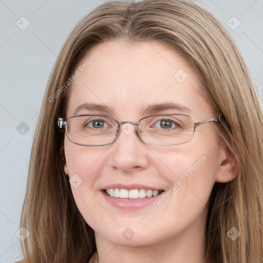 Joyful white adult female with long  brown hair and grey eyes