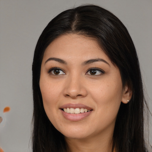 Joyful asian young-adult female with long  brown hair and brown eyes