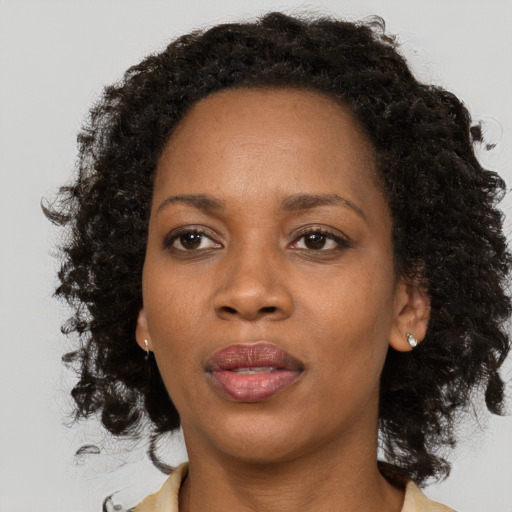 Neutral black adult female with medium  brown hair and brown eyes