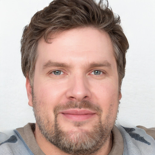 Joyful white adult male with short  brown hair and grey eyes