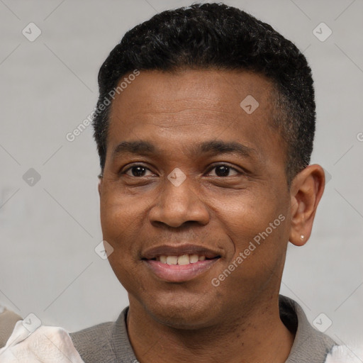 Joyful black young-adult male with short  black hair and brown eyes